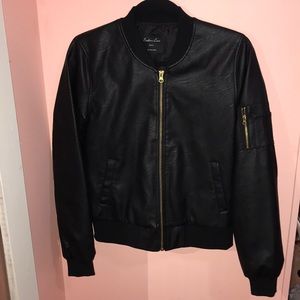 Black leather jacket with gold zipper